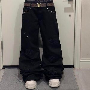 Custom flared studded distressed patched black denim pants